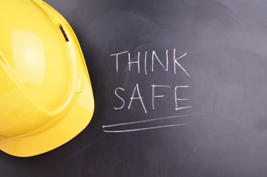 Hard had with "think safe" written on blackboard