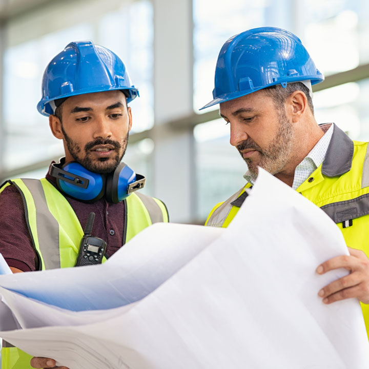 site-supervisor-and-construction-worker-look-at-plans