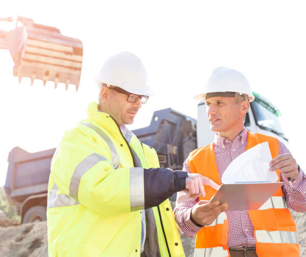 Two site managers looking over the construction site plans