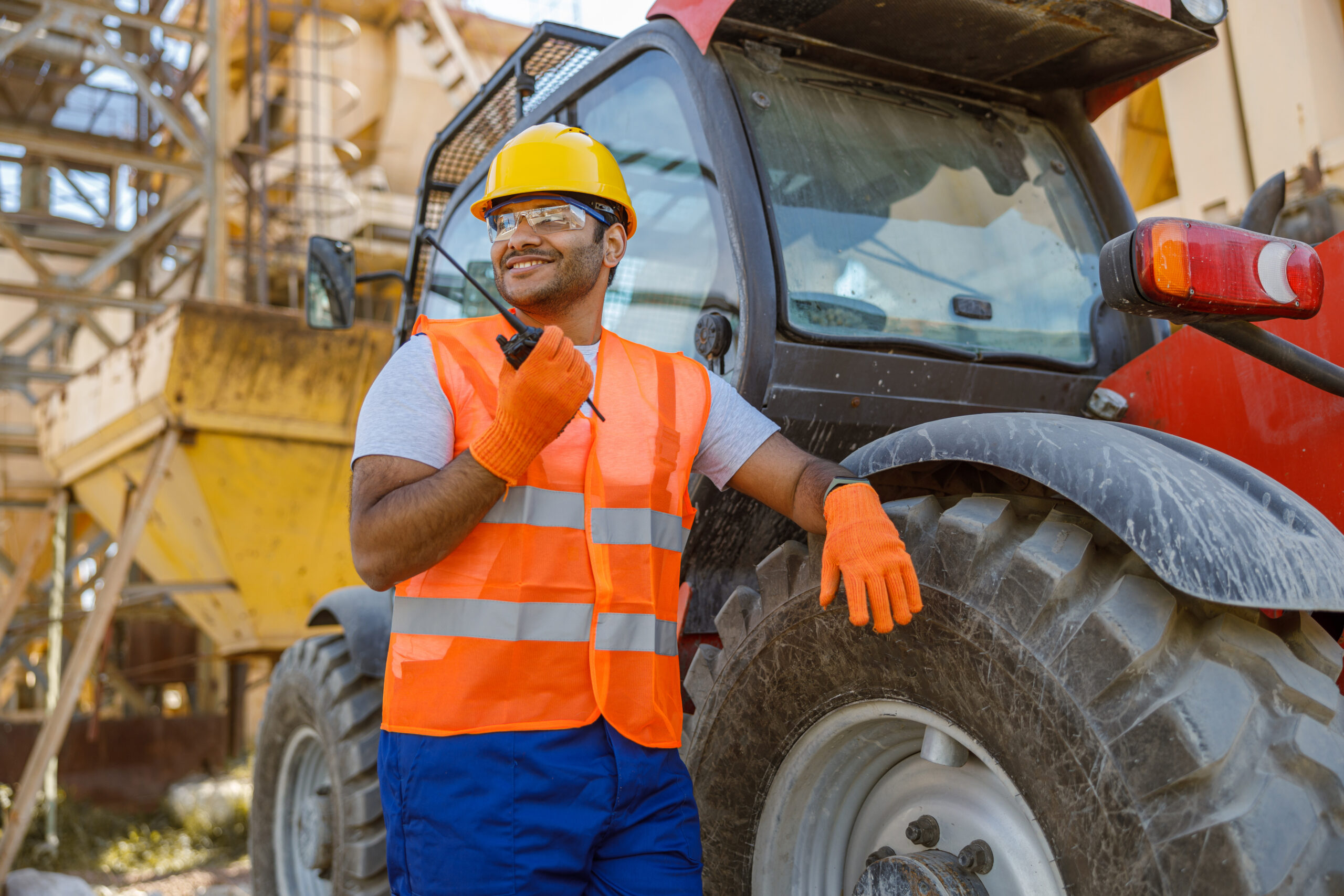 A man standing next to plant machinery