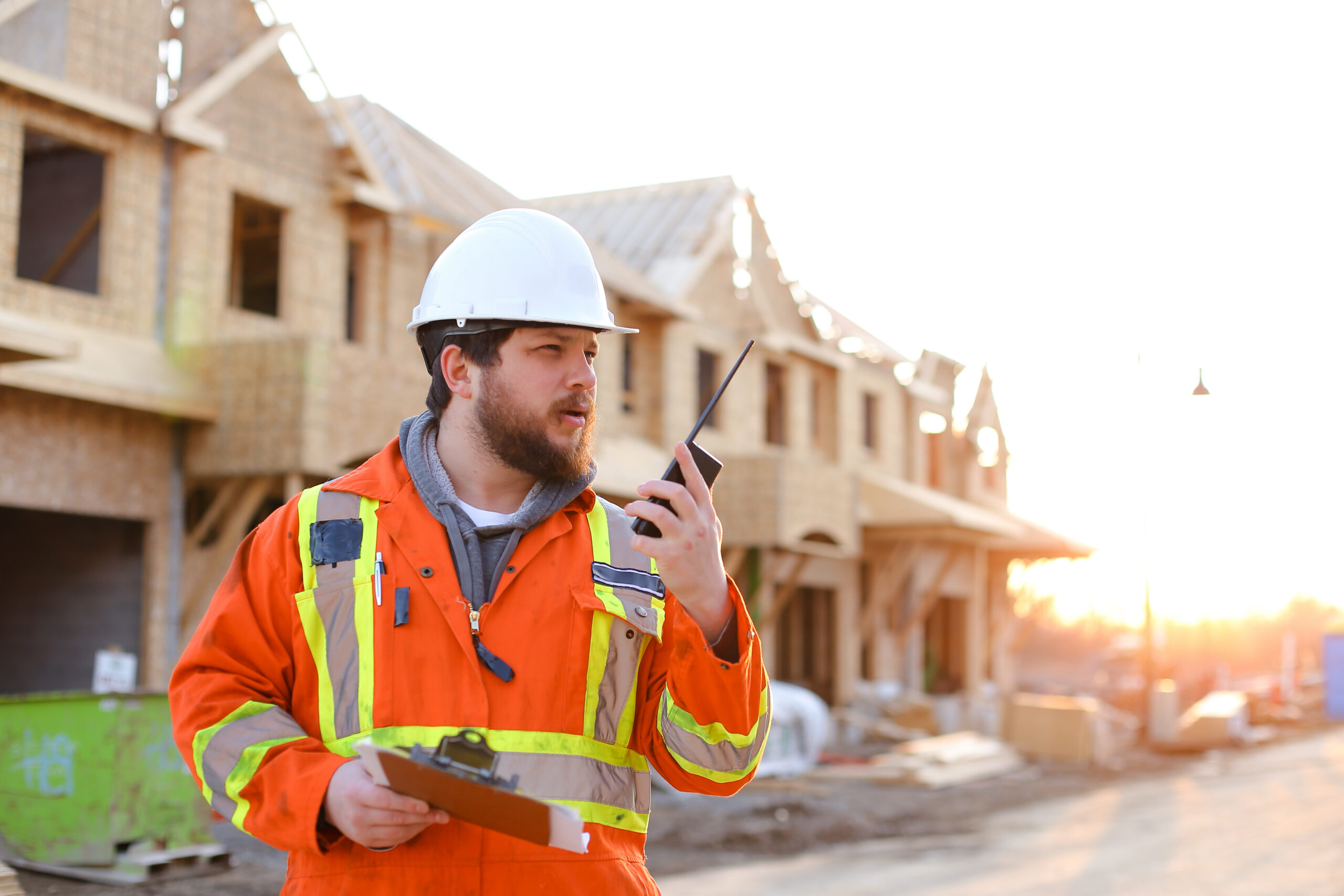 Construction Supervisor talking on a walkie talkie